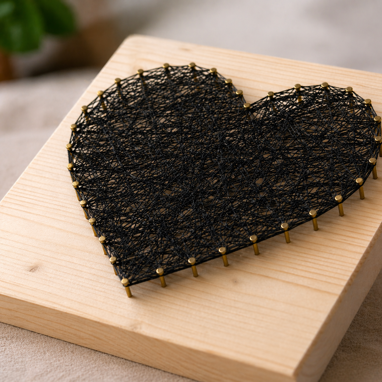 Finished heart string art with visible nail height and thread texture