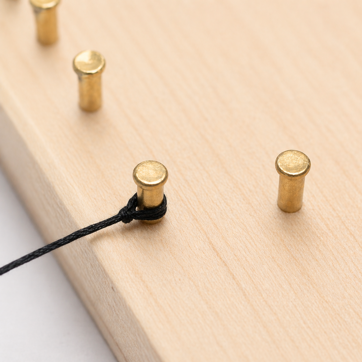 Starting knot tied around the first nail